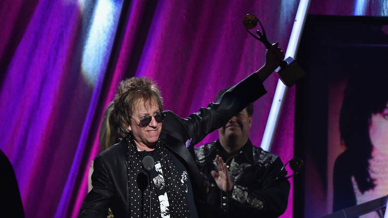 Ricky Byrd holds induction award