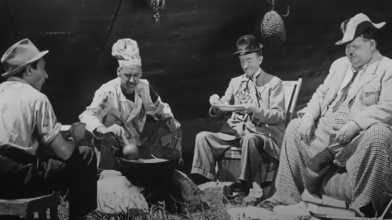 Laurel and Hardy eating at campfire