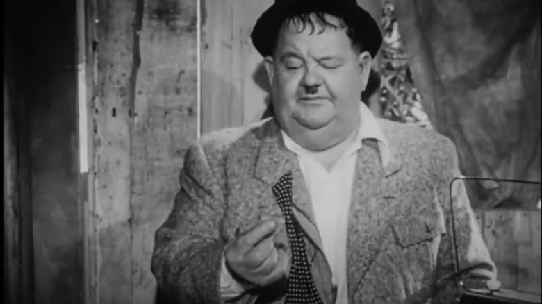 Oliver Hardy holding a pencil 