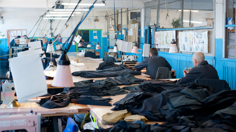 male prisoners sew uniforms at a sewing workshop