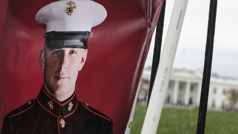 A banner with a picture of Trevor Reed, a U.S. Marine who is currently being detained in a Russian prison, hangs in Lafayette Park near the White House as Joey Reed and Paula Reed