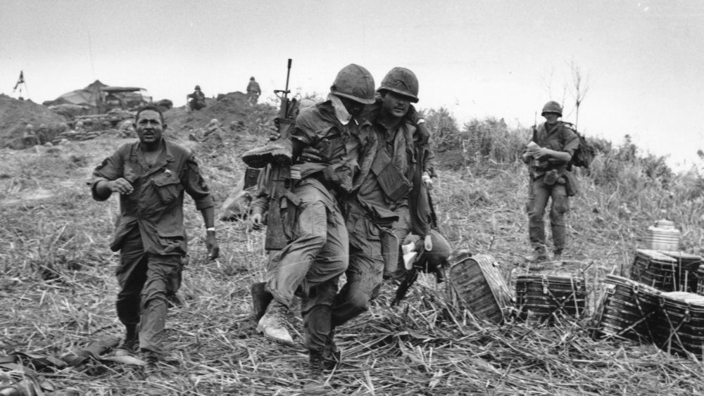 wounded soldier being carried in Vietnam