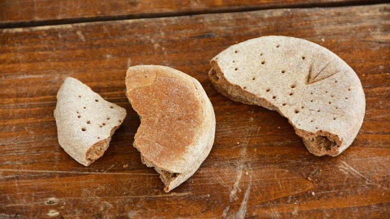 Broken hardtack biscuit on table