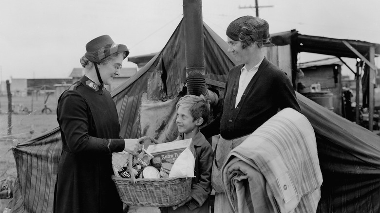 woman gives mother and son basket