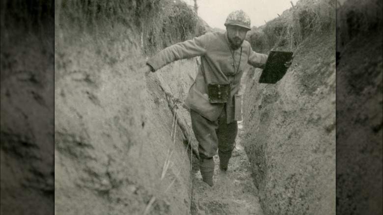 Soldier wading in trench mud