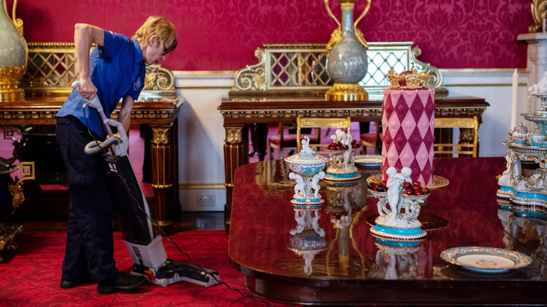 Woman vacuuming at Buckingham Palace