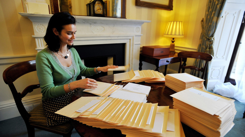 Woman sending out wedding invitations in Buckingham Palace