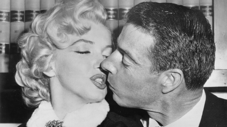 Joe DiMaggio kissing Marilyn Monroe