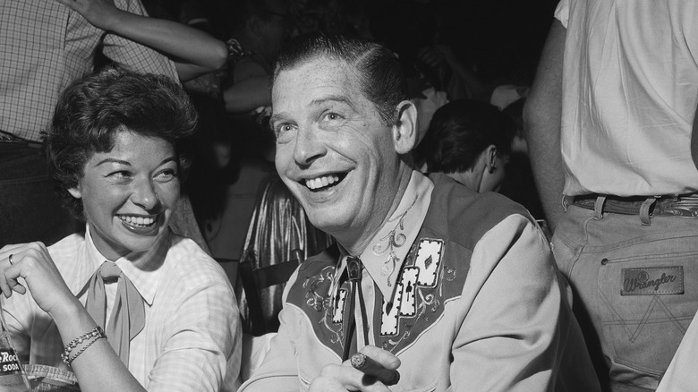 Milton Berle sitting at a party