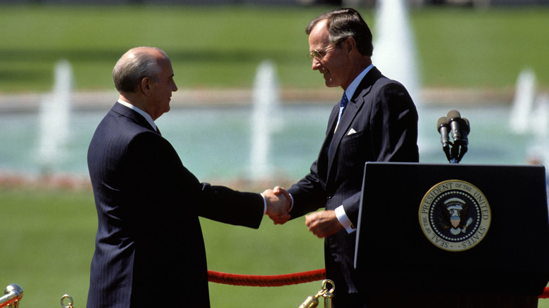 George H.W. Bush shakes hands with Mikhail Gorbachev