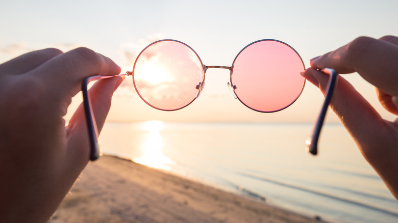 rose-colored glasses against sky