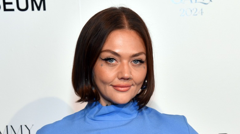 elle king smiling slyly at camera bob haircut blue dress