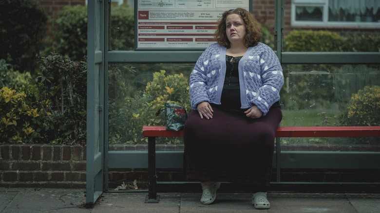 Martha sitting alone at bus station