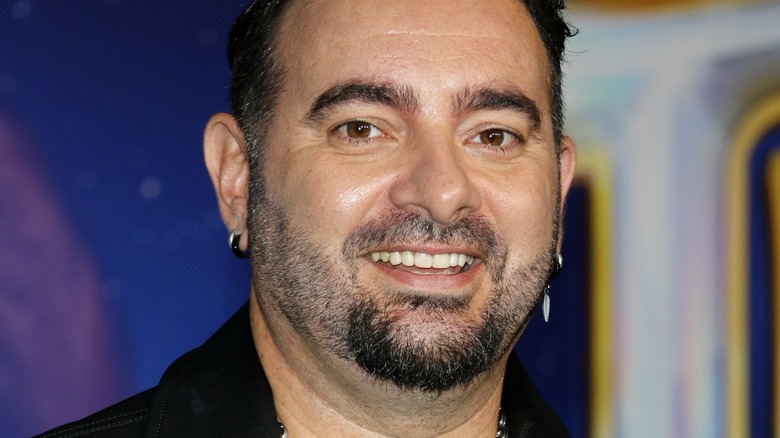 Chris Kirkpatrick smiling in dark clothes