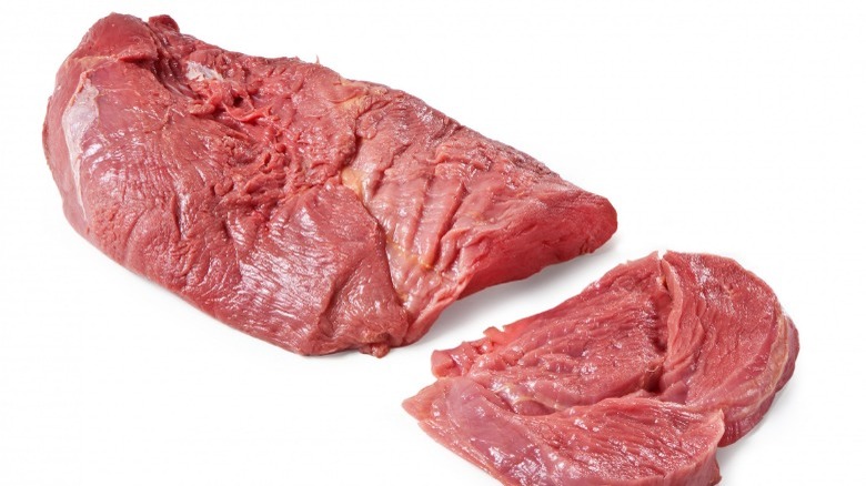 Raw horse meat white background