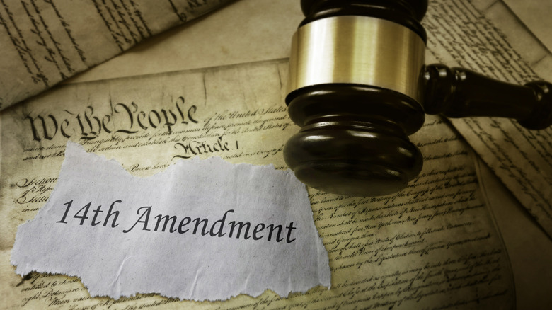 Gavel hovers over a copy of the Constitution with the 14th Amendment pasted over