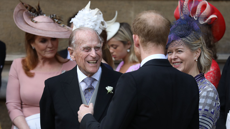 Prince Philip talking to Prince Harry at Princess Beatrice's wedding