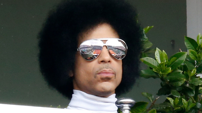 prince stars out sternly in mirrored shades