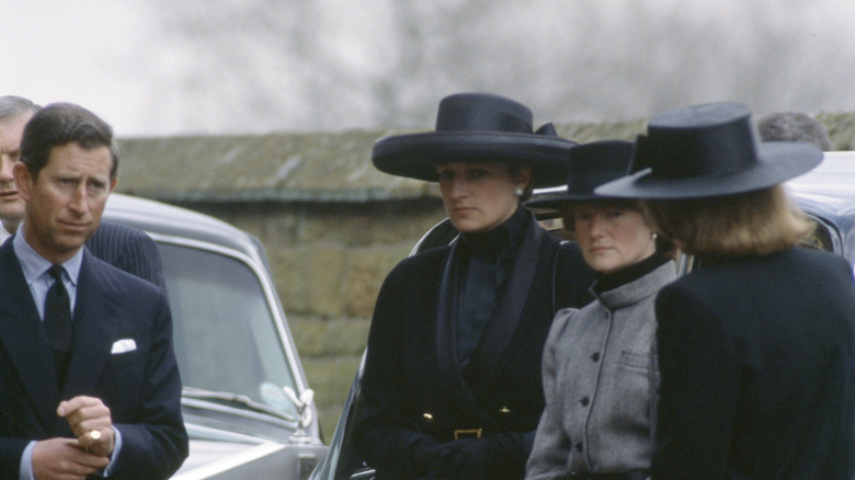 Princess Dianna, her sisters, and Prince Charles at a funeral