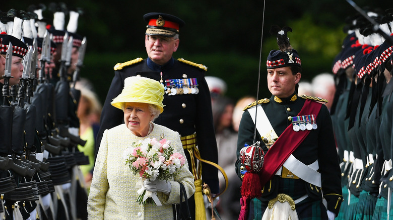 The queen reviews troops during a military inspection