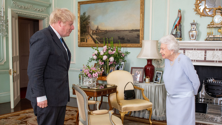 PM Boris Johnson and Queen Elizabeth chat for the cameras before their private meeting