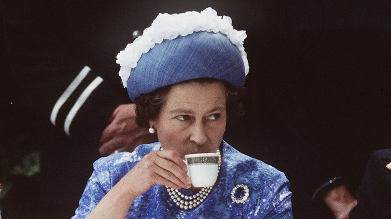 Queen Elizabeth enjoying a cup of tea