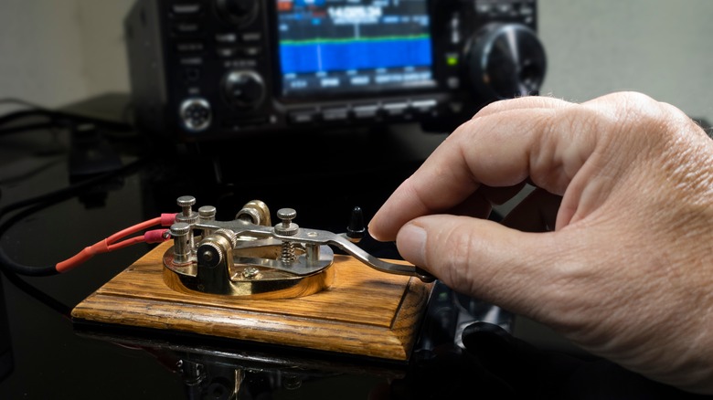 Hand touching a telegraph