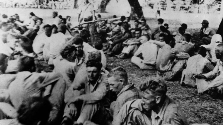 POWs at Bataan sitting on ground