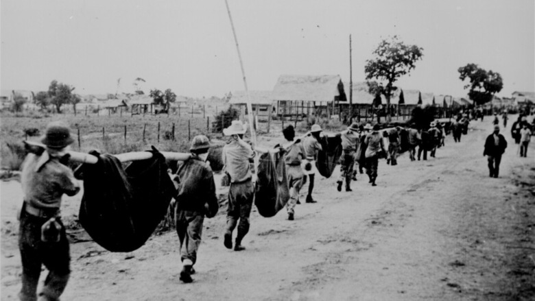 POWs marching along dirt road