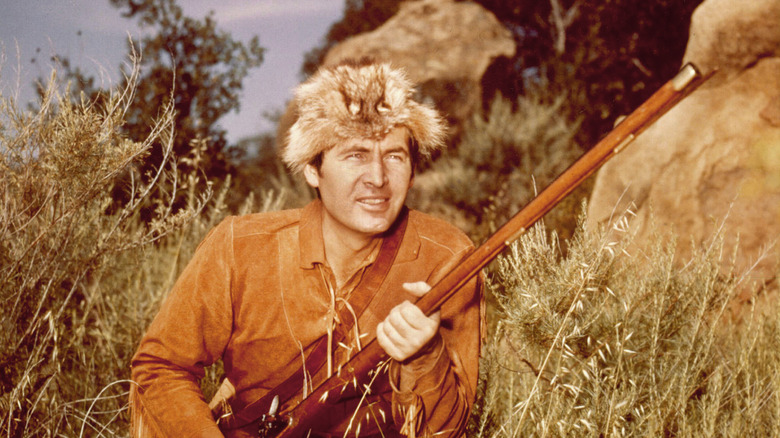 Actor Fess Parker as Davy Crockett wearing a coonskin cap