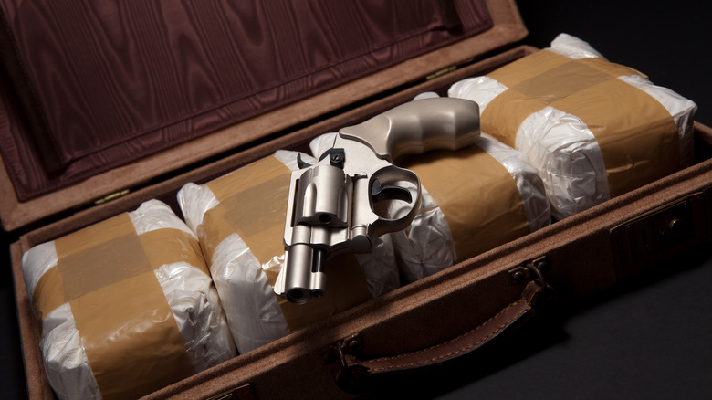 Gun on case of cocaine