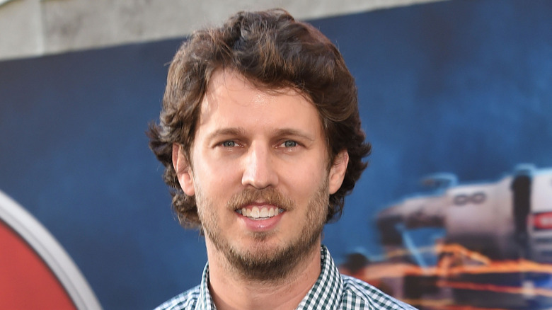 jon heder in plaid shirt smiling at movie premiere