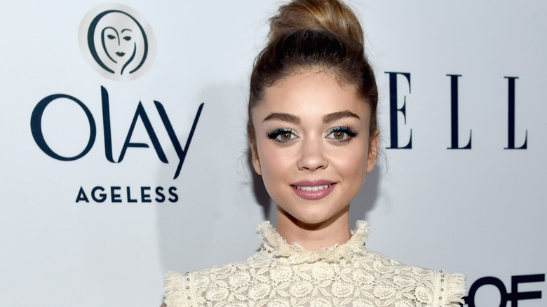 Sarah Hyland smiling white dress at Olay event