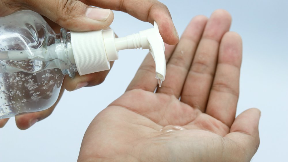 A person using hand sanitizer 