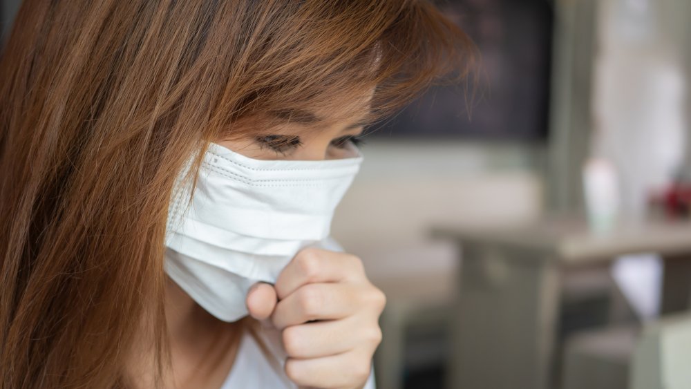 A woman wearing a face mask to stop the spread of a virus