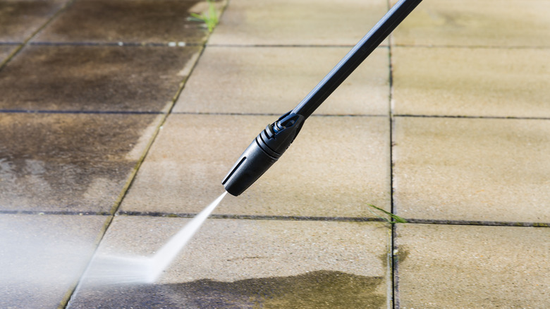 Water jet cleaning sidewalk