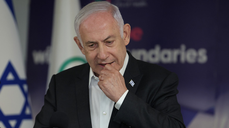 Benjamin Netanyahu with hand to mouth