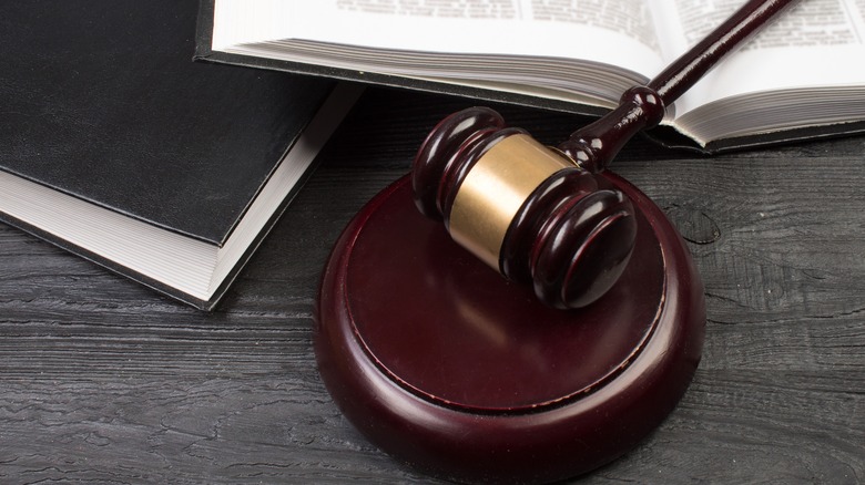 Gavel on table beside legal textbooks