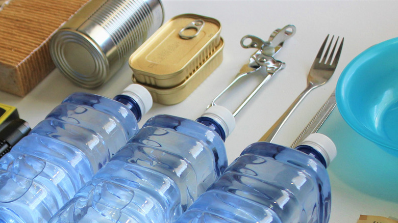 canned food and water on a table