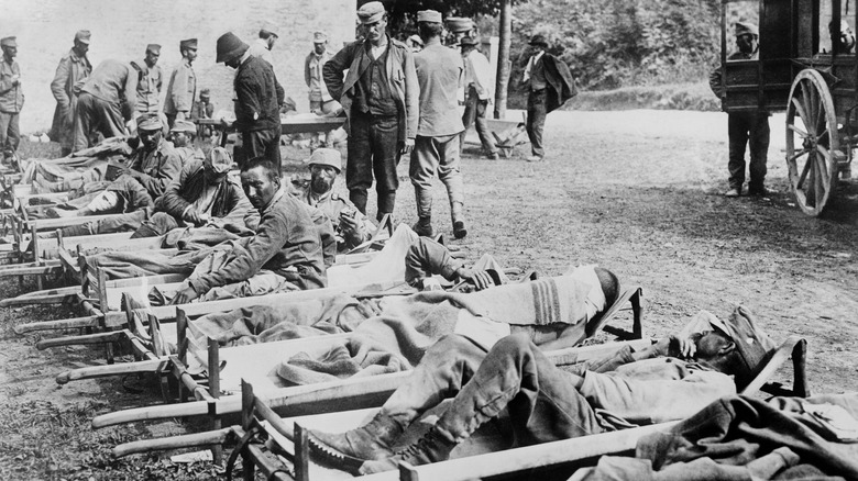 injured soldiers on stretchers