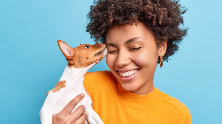 dog licking a woman's face