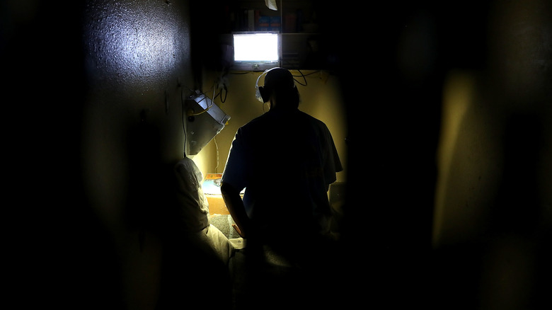 Inmate alone in a dark cell 