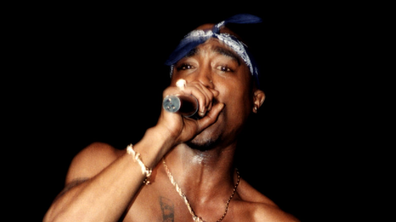 Tupac Shakur performing in blue bandana