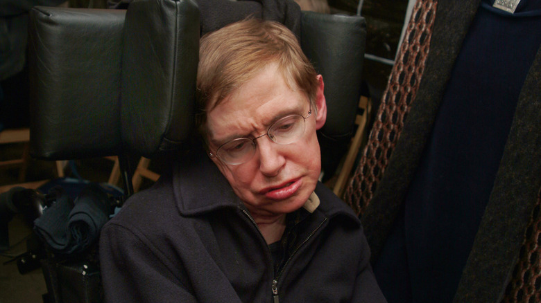 Hawking in chair looking down