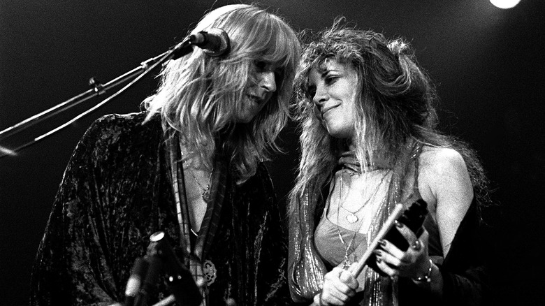 Chrstine McVie and Stevie Nicks performing with percussion