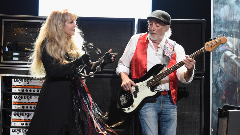 Stevie Nicks and John McVie performing on stage