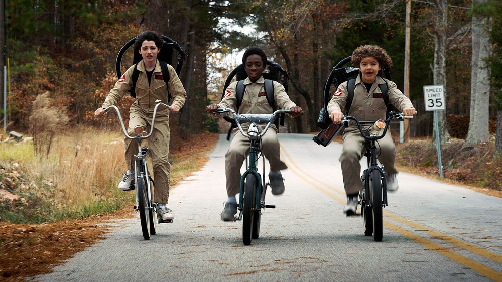 The kids riding bikes in their Ghostbusters outfits.