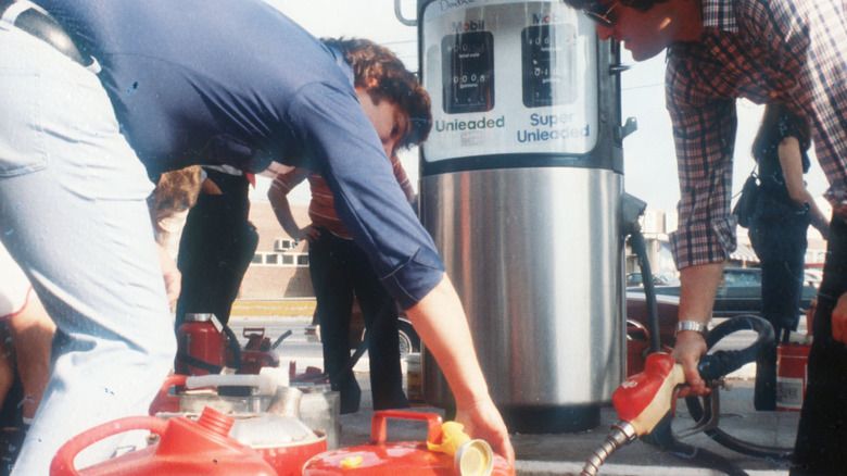 People filling up gas cans with extra gas