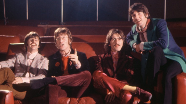 The Beatles sitting in a movie theater