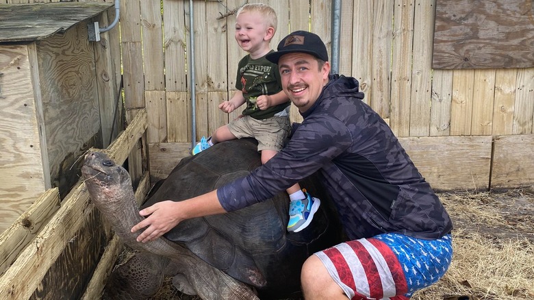 Karl Rasmussen and his son on a tortoise